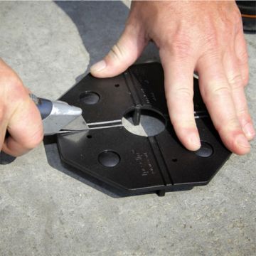 Deck Tile Connector (Black) being scored for trimming